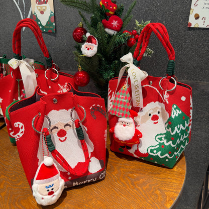 Red Christmas tote bags with Santa Claus and tree designs, decorated with festive ornaments.
