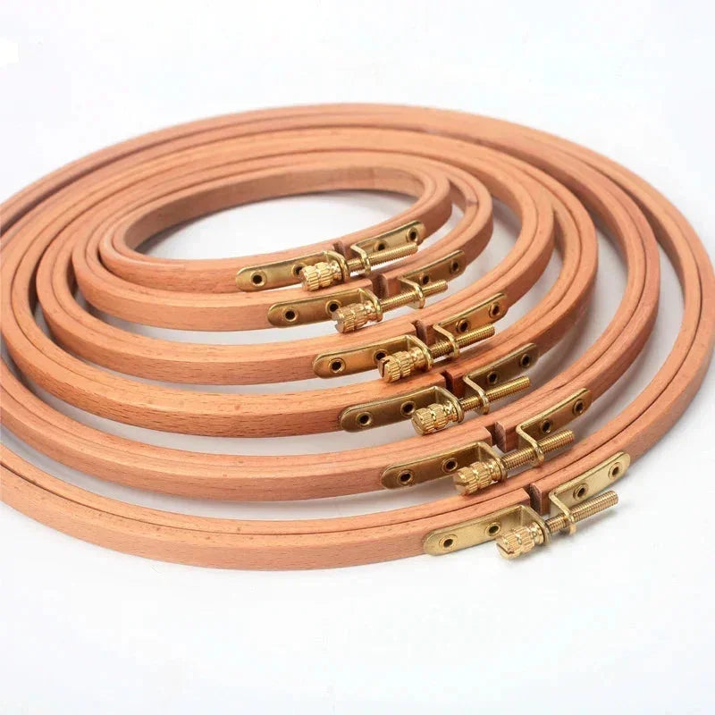 Set of premium beech wood embroidery hoops with gold-tone metal tightening screws.