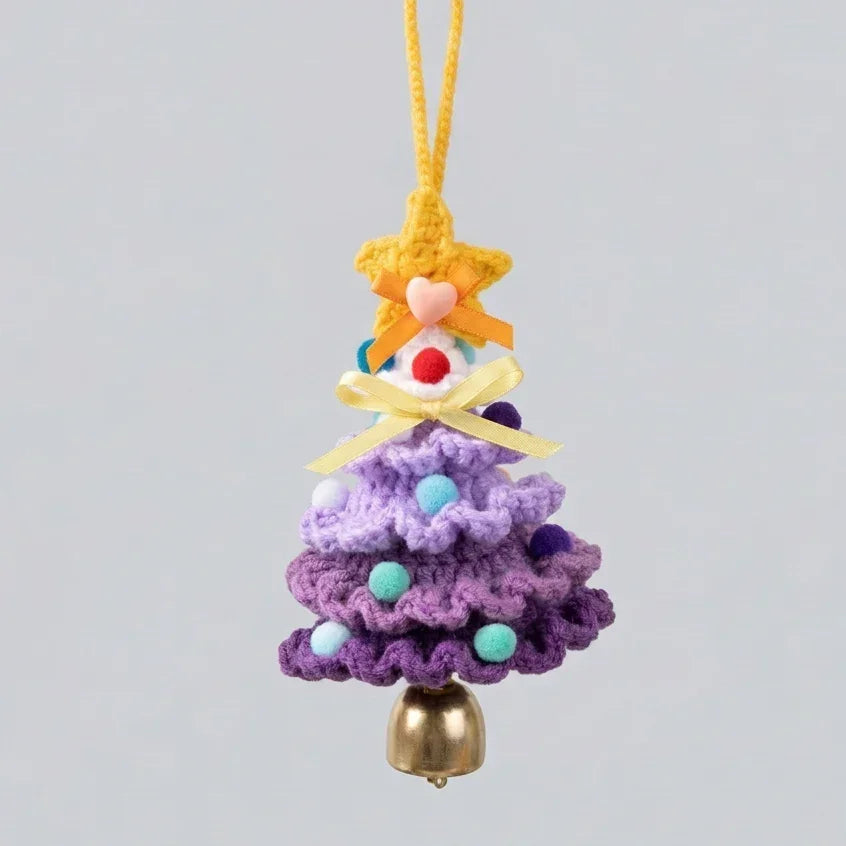 Handmade purple knitted Christmas tree ornament with a yellow star and gold bell by Calivra Craft