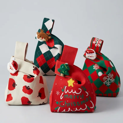 Set of four festive Christmas knitted gift bags with holiday patterns and plush ornaments.