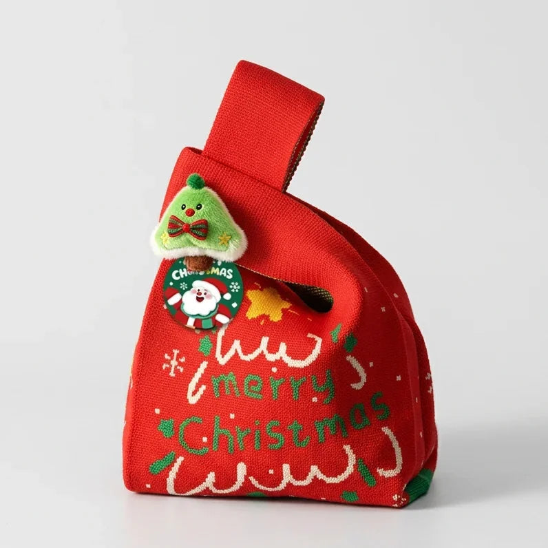 Red knitted Christmas gift bag by Calivra Craft with a festive tree and Santa charm.