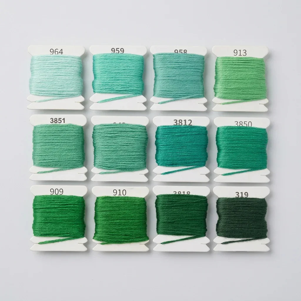 Calivra Craft 12-color gradient green 6 strand cotton embroidery floss set on white bobbins.