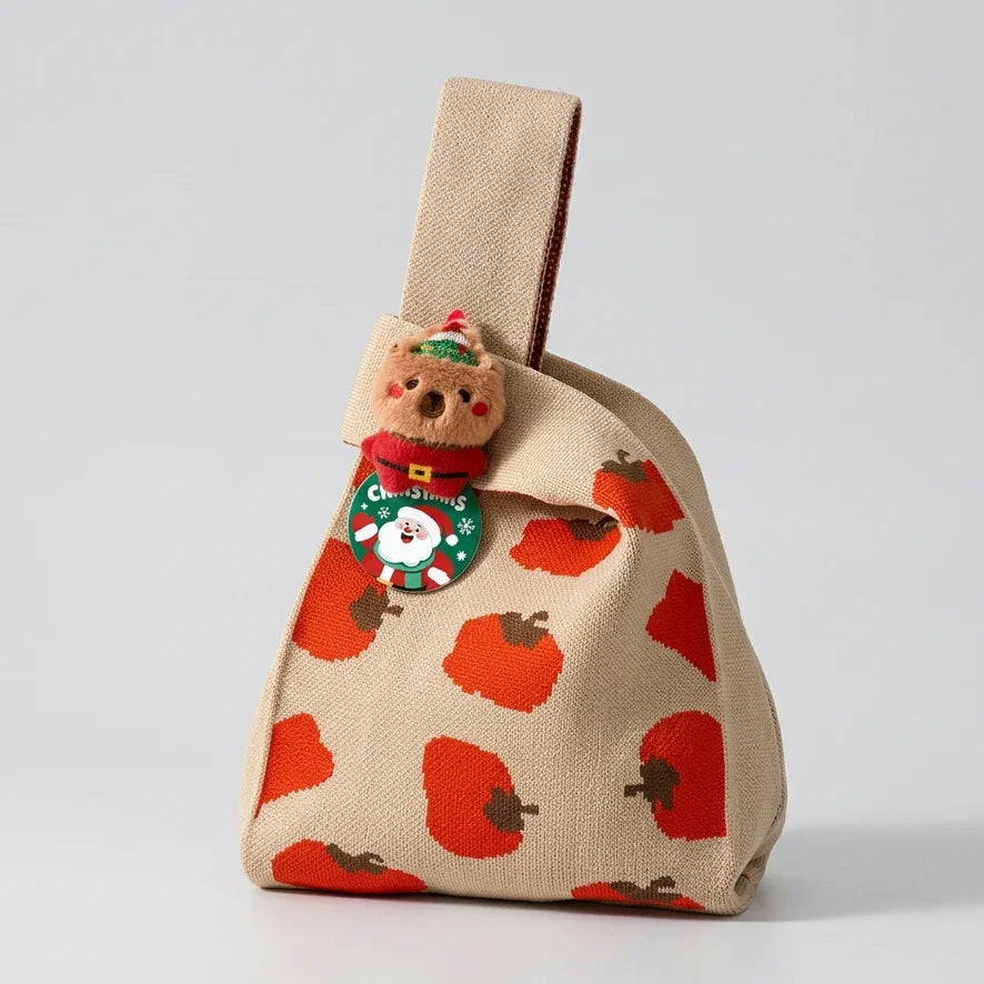 Beige Christmas knitted gift bag with red apple pattern and cute teddy bear charm.