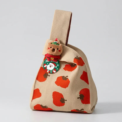 Beige Christmas knitted gift bag with red apple pattern and cute teddy bear charm.