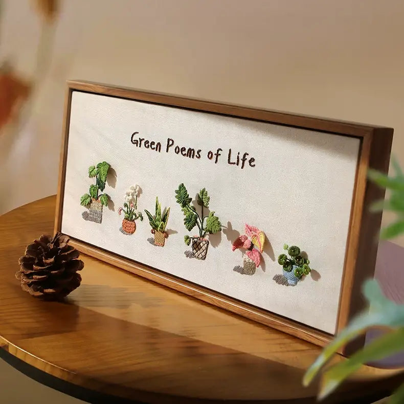 3D green plant embroidery kit featuring various potted botanical designs in a wooden frame.