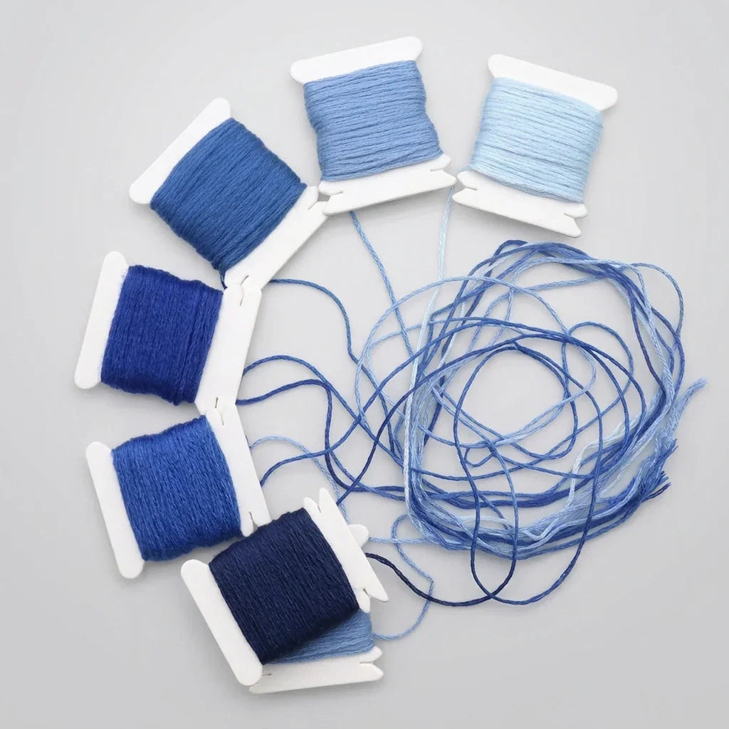 12-color gradient blue cotton embroidery floss set on white spools by Calivra Craft