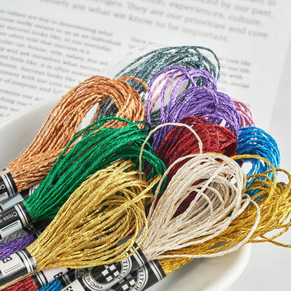 Colorful metallic embroidery floss skeins from Calivra Craft in a white bowl.