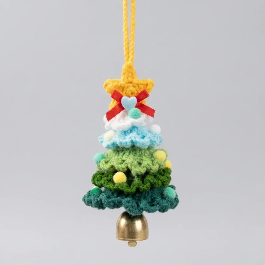 Handmade Calivra Craft knitted Christmas tree ornament with a yellow star and small bell.