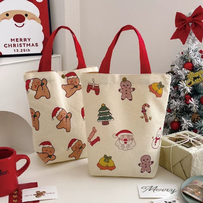 Two Christmas canvas gift bag storage totes with gingerbread man and Santa patterns.