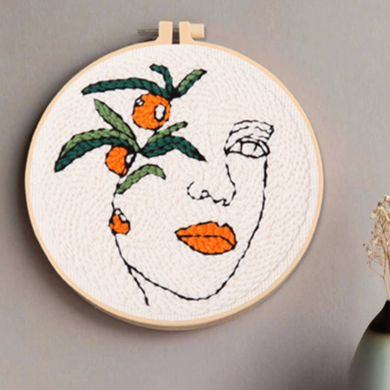 A woman’s face outlined in simple lines, with orange lips and fruit echoing each other — blending nature and inspiration.
