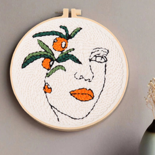 A woman’s face outlined in simple lines, with orange lips and fruit echoing each other — blending nature and inspiration.
