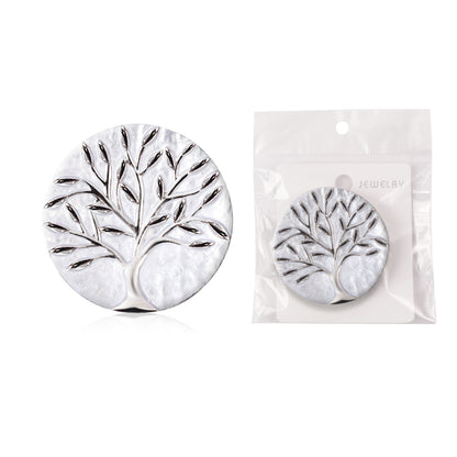 Silver tree-shaped earrings with packaging on a white background