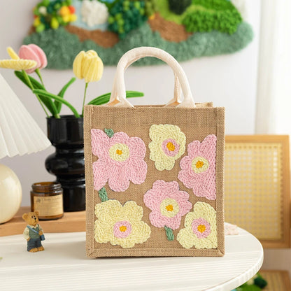 Jute bag with floral patterns on a table with decorative items in the background