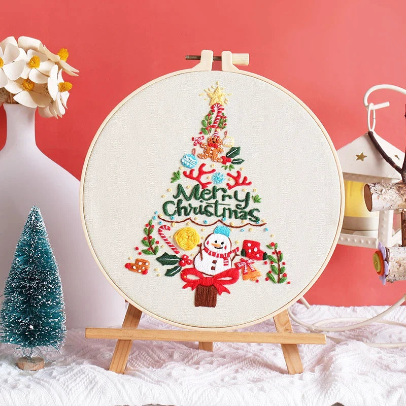 This charming embroidery design features a festive Christmas tree adorned with gifts, candy canes, stars, and a cheerful snowman at its base. The bright, vibrant colours capture the spirit of the holidays, making it perfect for Christmas décor or as a thoughtful handmade gift to share the warmth of the season.