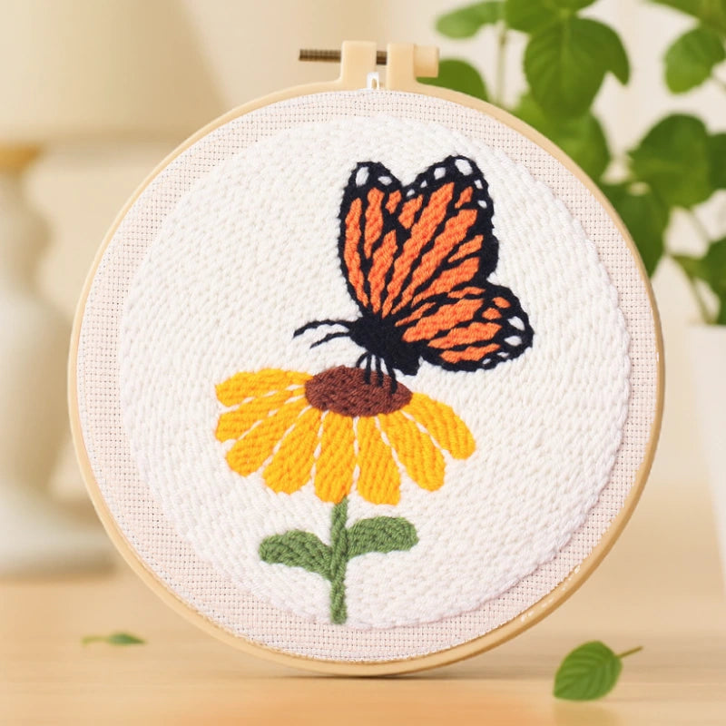 A graceful butterfly rests gently on a bright yellow flower, capturing the beauty of nature in a simple, elegant design. The bold colors and clean lines make it perfect for beginners and a lovely addition to any home décor.