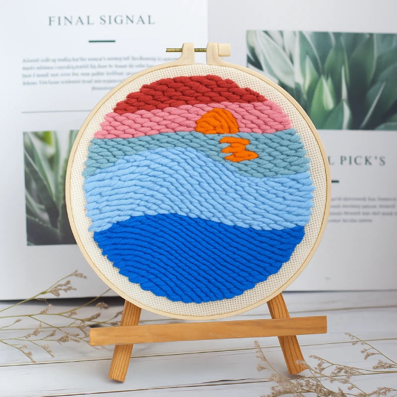 A warm sunset reflected over gentle blue waves, blending soft tones of red, orange, and sky blue for a tranquil seaside view.