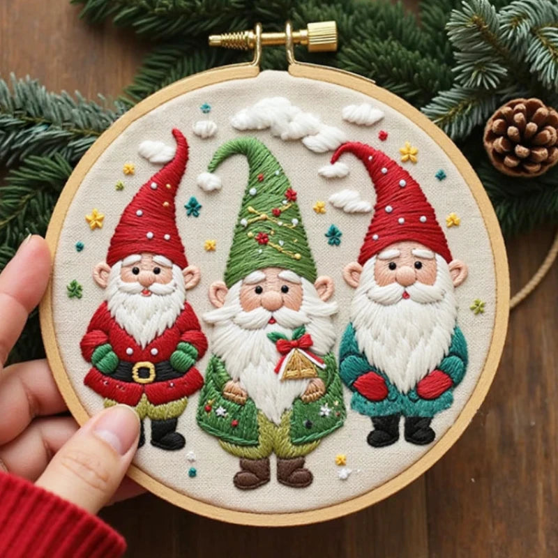 This cheerful embroidery design features three adorable Christmas gnomes dressed in festive red and green, surrounded by tiny stars and fluffy clouds. Each gnome’s outfit is detailed with delicate stitches, bringing warmth and joy to your holiday decor.
