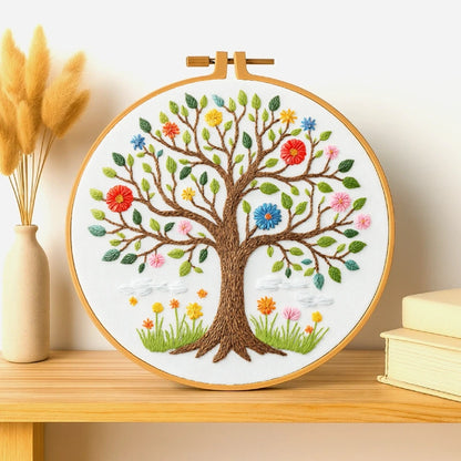 This elegant embroidery features a beautifully detailed tree of life, with colorful blossoms and leaves symbolising the changing seasons. The brown trunk and branches are richly textured, while the flowers in shades of red, yellow, pink, and blue add a lively, cheerful touch. Perfect for home décor, this design brings a sense of growth, balance, and natural beauty to any space.