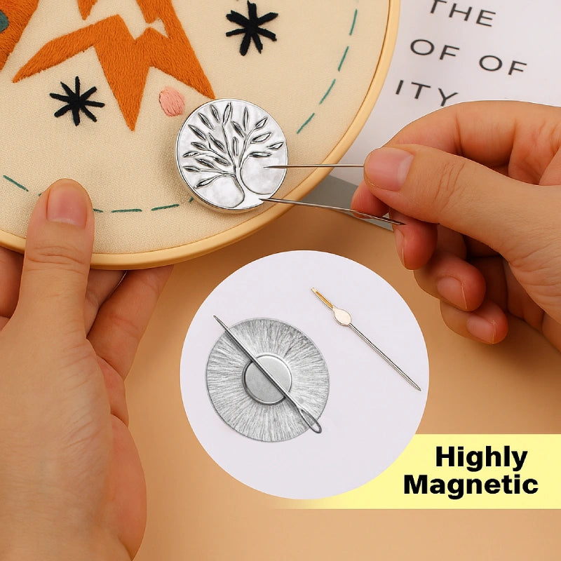 Person using a needle to work on a embroidery project with a close-up of a magnetic pin and needle.