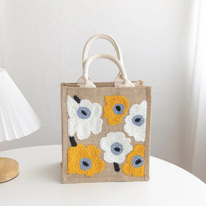 Jute bag with floral patterns on a white surface