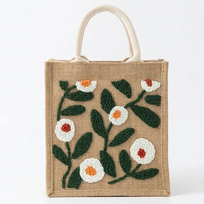Small beige jute tote bag with white and orange floral embroidery