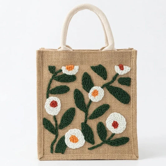 Small beige jute tote bag with white and orange floral embroidery