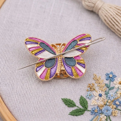 Calivra Craft butterfly magnetic needle minder in pink, purple, and teal on grey fabric