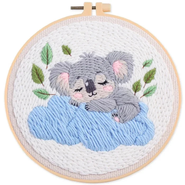 punch needle cute grey koala sleeping on a blue cloud with green leaves in a wooden hoop