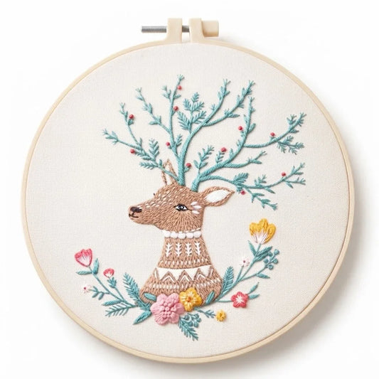 Embroidery hoop featuring a deer with floral antlers and colorful flowers.