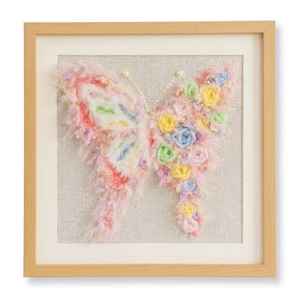 Floral butterfly punch needle kit by Calivra Craft in a light wood frame.