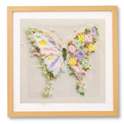 Floral butterfly punch needle embroidery art in a wooden frame by Calivra Craft.