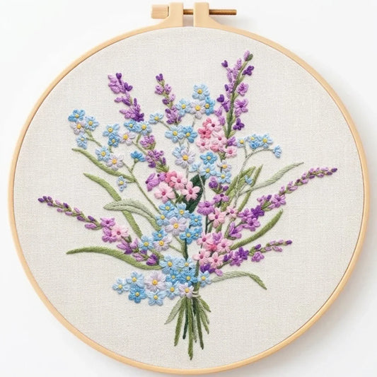 Handmade floral embroidery kit featuring a colorful wildflower bouquet in a wooden hoop.