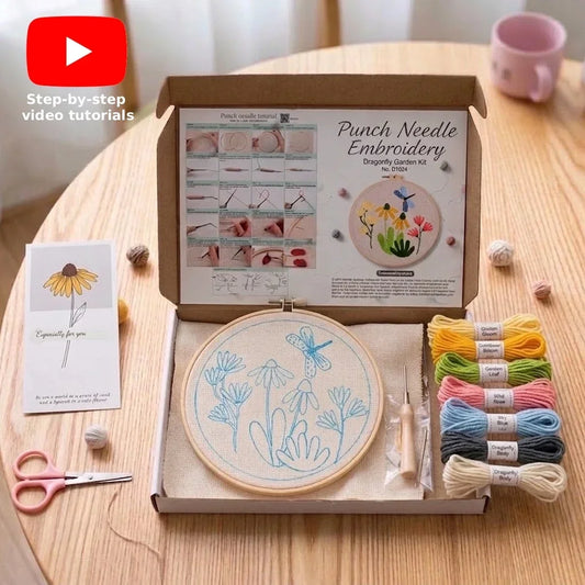 Punch needle embroidery kit with a flower pattern, colorful yarn, and instructions.
