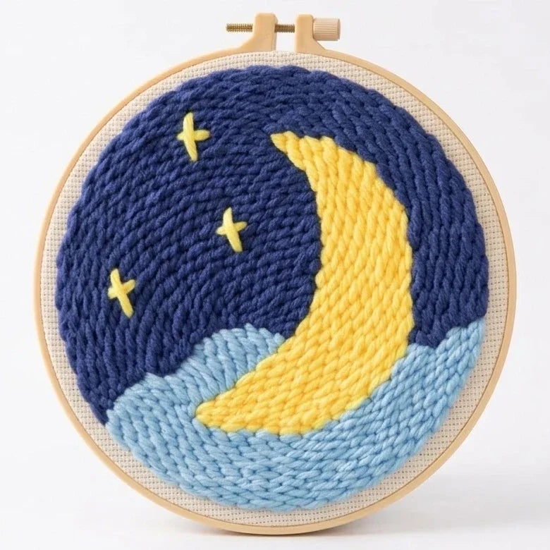 Handcrafted yarn embroidery art of a yellow crescent moon and stars in a dark blue night sky