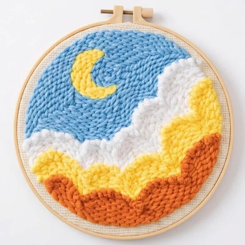 Handmade punch needle embroidery hoop art featuring a yellow crescent moon in a blue sky.