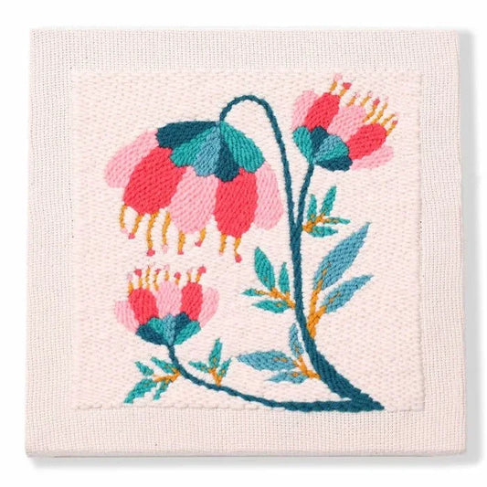 Punch needle pink floral design on a white textile square