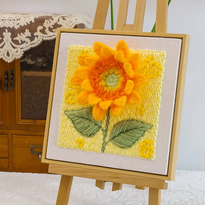 Completed Calivra Craft sunflower punch needle embroidery art on a small wooden easel